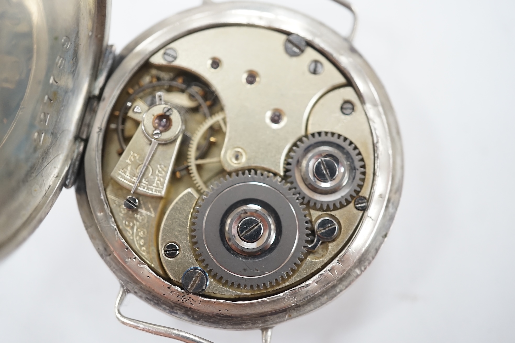 A George V silver manual wind trench watch with 'telephone dial' shrapnel guard, case import marked for London, 1917, case diameter 35mm, lacking winding crown. No strap. Condition - poor